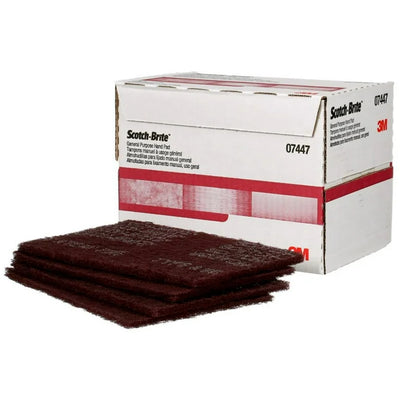 Box of Scotch-Brite sanding pads with three pads in front on a white background