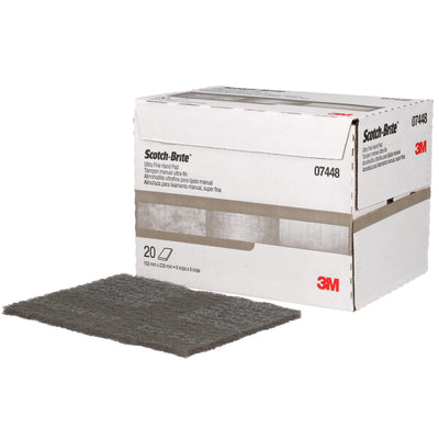 Box of Scotch-Brite sanding pads with a single pad in front on a white background